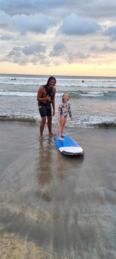 Andrew giving a surf lesson at Kuta Beach, Bali, at sunset