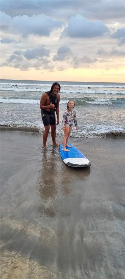 Andrew giving a surf lesson at Kuta Beach, Bali, at sunset
