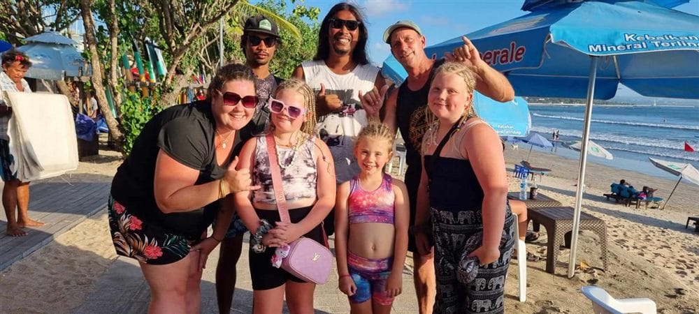 Andrew with a family of guests on Kuta Beach, Bali