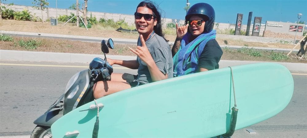 Andrew taking a guest to surf by scooter in Bali