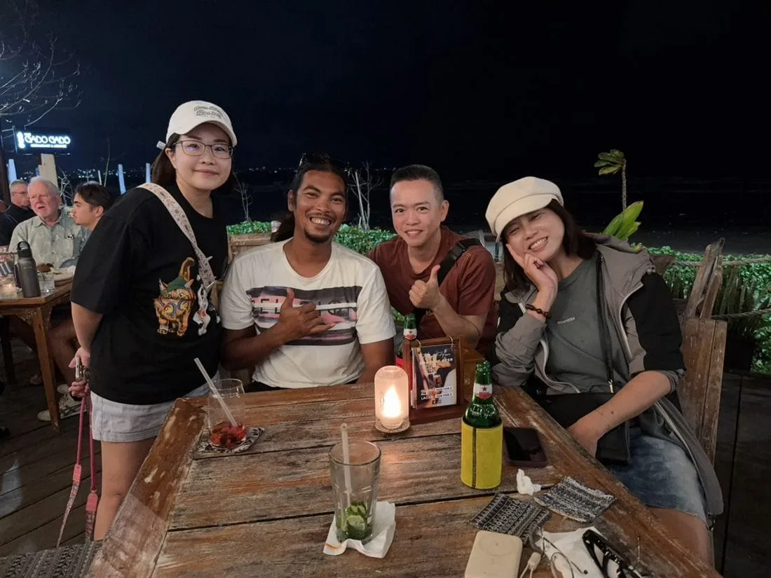 Andrew with happy guests at a beachfront restaurant in Kuta, Bali