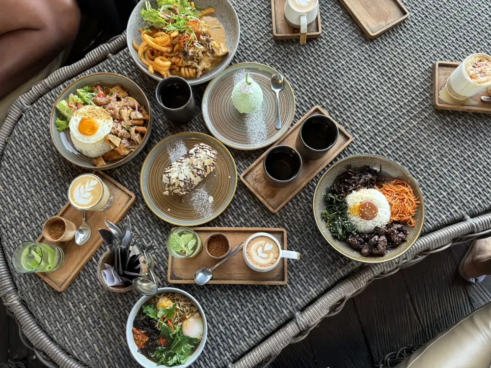 A brunch spread of Indonesian and Western dishes with coffee on a table at Akasa Specialty Coffee, Kintamani, Bali