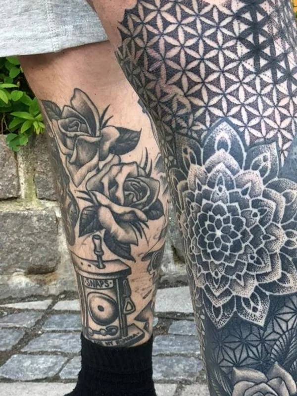 Detailed black-and-grey dotwork, mandala and rose leg tattoos done at a Kuta studio in Bali