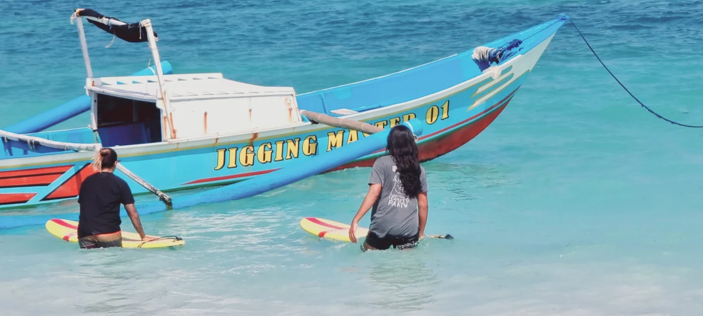 A colourful traditional Bali jukung boat on clear turquoise water near Kuta, Bali