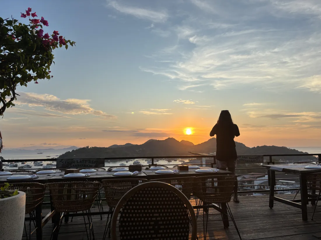 日落時,Labuan Bajo 的 Taman Laut Handayani Seafood Restaurant 用餐平台,擺好晚餐的桌子和花