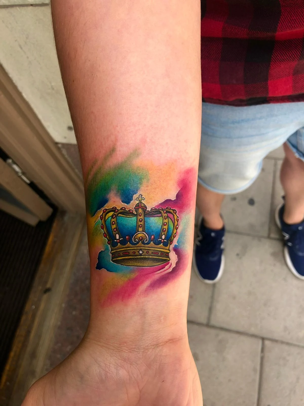 Colourful watercolour crown tattoo on the forearm, done at a Kuta, Bali studio