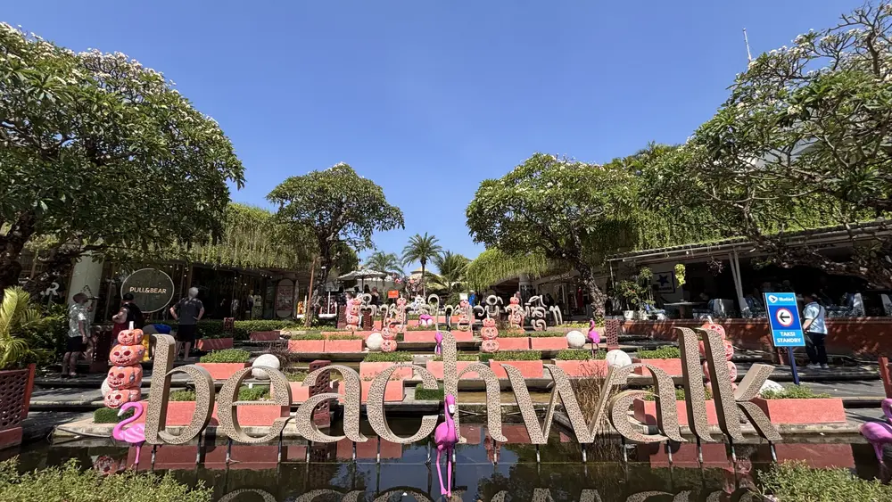 The entrance to the Beachwalk shopping centre in Kuta, Bali, with its water feature, frangipani trees and seasonal decorations