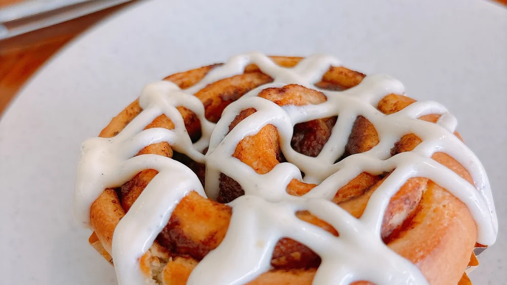 A cinnamon roll with cream cheese icing at Privecafe, Kuta, Bali