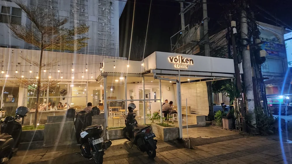 Volken Coffee storefront lit up in the evening, Kuta, Bali