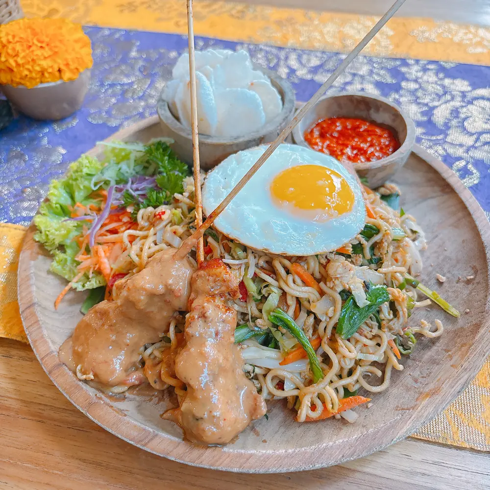 A plate of Indonesian noodles with fried egg, chicken and sambal at a warung in Ubud, Bali
