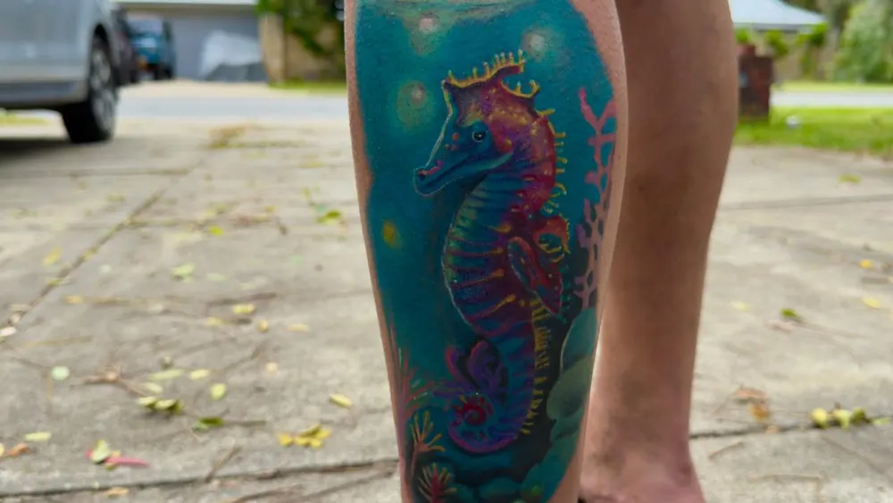 A colourful seahorse tattoo on the calf, done at a Kuta, Bali studio