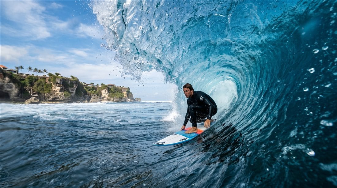 Surfer at golden hour on Kuta Beach, Bali